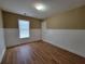 Neutral bedroom showcasing hardwood floors and a double-hung window with natural light at 1745 Collines Sw Ave, Atlanta, GA 30331