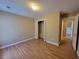 Comfortable bedroom with wood flooring, closet, and inviting doorway at 1745 Collines Sw Ave, Atlanta, GA 30331