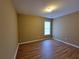 This cozy bedroom is completed with wood floors and a bright window at 1745 Collines Sw Ave, Atlanta, GA 30331