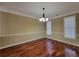 Bright dining room featuring hardwood floors, decorative lighting, and large windows at 1745 Collines Sw Ave, Atlanta, GA 30331