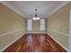 Bright dining room featuring hardwood floors, decorative lighting, and large windows at 1745 Collines Sw Ave, Atlanta, GA 30331