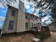 Two story home features a deck, neutral siding, and a tall brick chimney at 1745 Collines Sw Ave, Atlanta, GA 30331