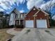 Charming two-story home with a brick and siding exterior and a two-car garage at 1745 Collines Sw Ave, Atlanta, GA 30331