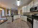 Spacious kitchen with stainless steel appliances, granite countertops, and tile flooring at 1745 Collines Sw Ave, Atlanta, GA 30331