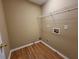 Compact laundry room space featuring wood flooring and washer hookups at 1745 Collines Sw Ave, Atlanta, GA 30331