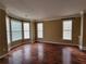 Inviting living room featuring gleaming hardwood floors, large windows, and abundant natural light at 1745 Collines Sw Ave, Atlanta, GA 30331
