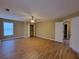 Spacious main bedroom with wood flooring, ceiling fan, and doorway to en-suite bathroom at 1745 Collines Sw Ave, Atlanta, GA 30331