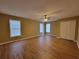 Spacious main bedroom with wood flooring, ceiling fan, and windows with natural light at 1745 Collines Sw Ave, Atlanta, GA 30331