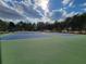Community tennis courts feature a blue and green court with benches and mature trees at 1745 Collines Sw Ave, Atlanta, GA 30331