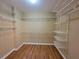 Walk-in closet featuring wooden floors and white wire shelving at 1745 Collines Sw Ave, Atlanta, GA 30331
