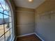 View of a small walk-in closet with wood floor, shelving and arched window at 1745 Collines Sw Ave, Atlanta, GA 30331