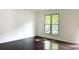 Sunlit bedroom with gleaming wood floors and a large window providing ample natural light at 1807 Queen Anne Ct, Sandy Springs, GA 30350