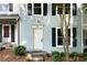 Charming townhome exterior with light blue siding, dark shutters and well maintained landscape at 1807 Queen Anne Ct, Sandy Springs, GA 30350