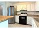 Efficient kitchen with white cabinets, updated appliances, and practical tile flooring at 1807 Queen Anne Ct, Sandy Springs, GA 30350