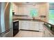 Functional kitchen offers white cabinetry, updated appliances, and ample counter space for meal prep at 1807 Queen Anne Ct, Sandy Springs, GA 30350