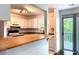 Open kitchen with breakfast bar and white cabinets, and sliding glass doors to deck at 1807 Queen Anne Ct, Sandy Springs, GA 30350
