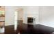 Bright living room boasts a fireplace and gleaming hardwood floors, flowing into the dining area at 1807 Queen Anne Ct, Sandy Springs, GA 30350