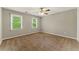 Spacious bedroom featuring carpet flooring, two windows, and a ceiling fan at 2068 Signal Ridge Nw, Kennesaw, GA 30152