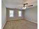 Neutral bedroom with ceiling fan, large windows, and plush carpeting at 2068 Signal Ridge Nw, Kennesaw, GA 30152