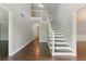 Bright foyer with wood floors, white staircase, and natural light at 2068 Signal Ridge Nw, Kennesaw, GA 30152
