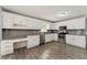 Bright kitchen with white cabinets, stainless steel appliances, and gray backsplash at 2068 Signal Ridge Nw, Kennesaw, GA 30152