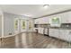 Eat-in kitchen featuring white cabinets, stainless steel appliances, and gray backsplash at 2068 Signal Ridge Nw, Kennesaw, GA 30152