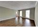Cozy living room featuring hardwood floors and natural light from two large windows at 2068 Signal Ridge Nw, Kennesaw, GA 30152