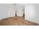 Spacious bedroom showcasing new laminate flooring, large closet, and doorway to the hallway at 3652 Platina Park Ct, Decatur, GA 30034