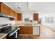 Kitchen showcasing light laminate floors and stainless steel and white appliances at 3652 Platina Park Ct, Decatur, GA 30034