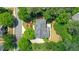 Aerial view of a landscaped home featuring a deck, mature trees, manicured garden, and a paved driveway at 6030 Sweet Creek Rd, Duluth, GA 30097
