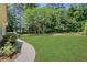 Large, well-maintained lawn with mature trees and landscaping at 6030 Sweet Creek Rd, Duluth, GA 30097