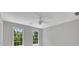 Bright bedroom featuring natural light from two windows and a ceiling fan at 6030 Sweet Creek Rd, Duluth, GA 30097