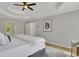 This bedroom features a tray ceiling, a ceiling fan and neutral paint at 6030 Sweet Creek Rd, Duluth, GA 30097