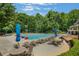 Resort-style pool area with lounge chairs and umbrellas at 6030 Sweet Creek Rd, Duluth, GA 30097