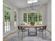 Bright dining area with modern lighting, backyard view and adjacent to a door that leads to the backyard at 6030 Sweet Creek Rd, Duluth, GA 30097