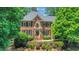 Beautiful two-story brick home with manicured landscaping, symmetrical design, and a welcoming front entrance at 6030 Sweet Creek Rd, Duluth, GA 30097