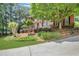 Charming brick home with lush landscaping and a well-manicured lawn at 6030 Sweet Creek Rd, Duluth, GA 30097