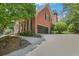 Brick home with black garage doors and driveway at 6030 Sweet Creek Rd, Duluth, GA 30097