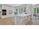 Bright, all-white kitchen with quartz counters, stainless steel appliances, and a breakfast bar perfect for casual dining at 6030 Sweet Creek Rd, Duluth, GA 30097
