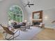 Spacious living room with a soaring arched window, fireplace with brick accent, and a cozy seating area at 6030 Sweet Creek Rd, Duluth, GA 30097