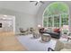 Bright living room with a vaulted ceiling, large windows, and modern furniture at 6030 Sweet Creek Rd, Duluth, GA 30097