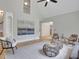 Open living area featuring a large gray rug, modern seating, and stairs leading to second level at 6030 Sweet Creek Rd, Duluth, GA 30097
