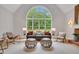 Open concept living room with a large arch window, vaulted ceilings, and comfortable seating at 6030 Sweet Creek Rd, Duluth, GA 30097