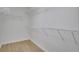 This walk-in closet has white wire shelving and hardwood floors at 6030 Sweet Creek Rd, Duluth, GA 30097