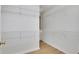 A simple walk-in closet with white wire shelving and hardwood floors at 6030 Sweet Creek Rd, Duluth, GA 30097
