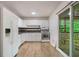 Functional kitchen with white cabinets and modern appliances, with sliding glass doors to backyard deck at 8169 Kendrick Rd, Jonesboro, GA 30238
