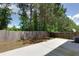 This fenced backyard features a patio and mature trees at 301 Silver Spring St, Dallas, GA 30157