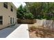 A backyard with a patio, fenced yard, and mature trees at 301 Silver Spring St, Dallas, GA 30157