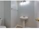 Powder room with pedestal sink and modern light fixture at 301 Silver Spring St, Dallas, GA 30157