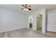 A bedroom with durable flooring, ceiling fan, and entrances to a bathroom and walk-in closet at 301 Silver Spring St, Dallas, GA 30157